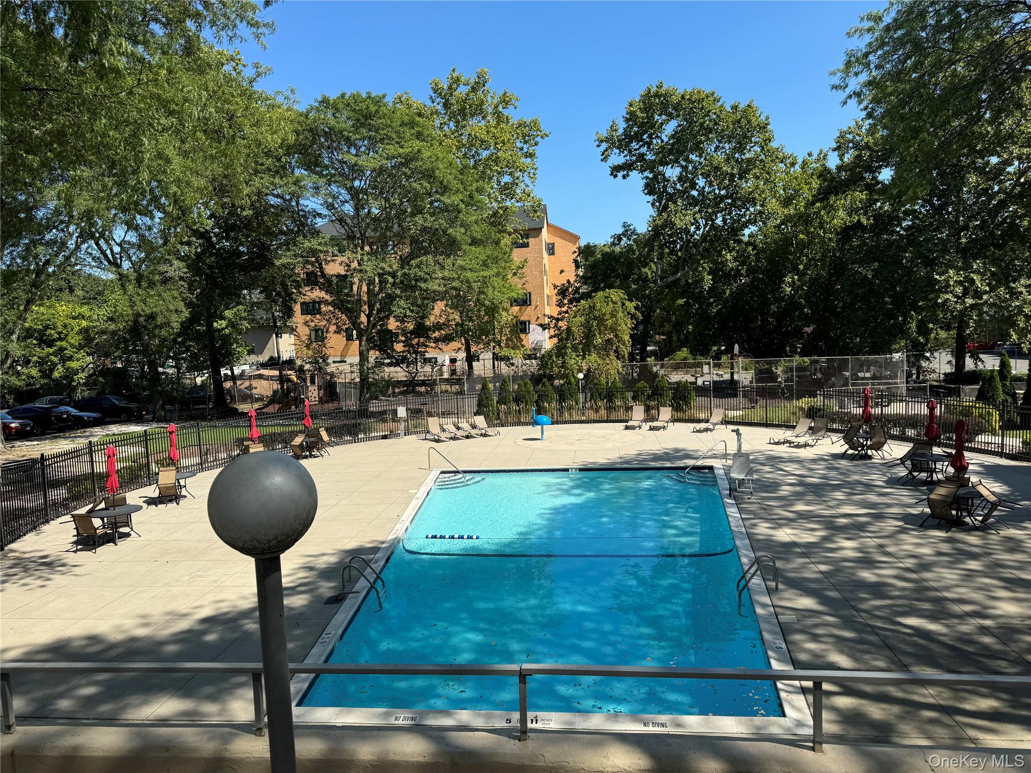 30 South Cole Avenue, Unit 1L Spring Valley, NY 10977 - Photo 21 of 29 a view of swimming pool with table and chairs
