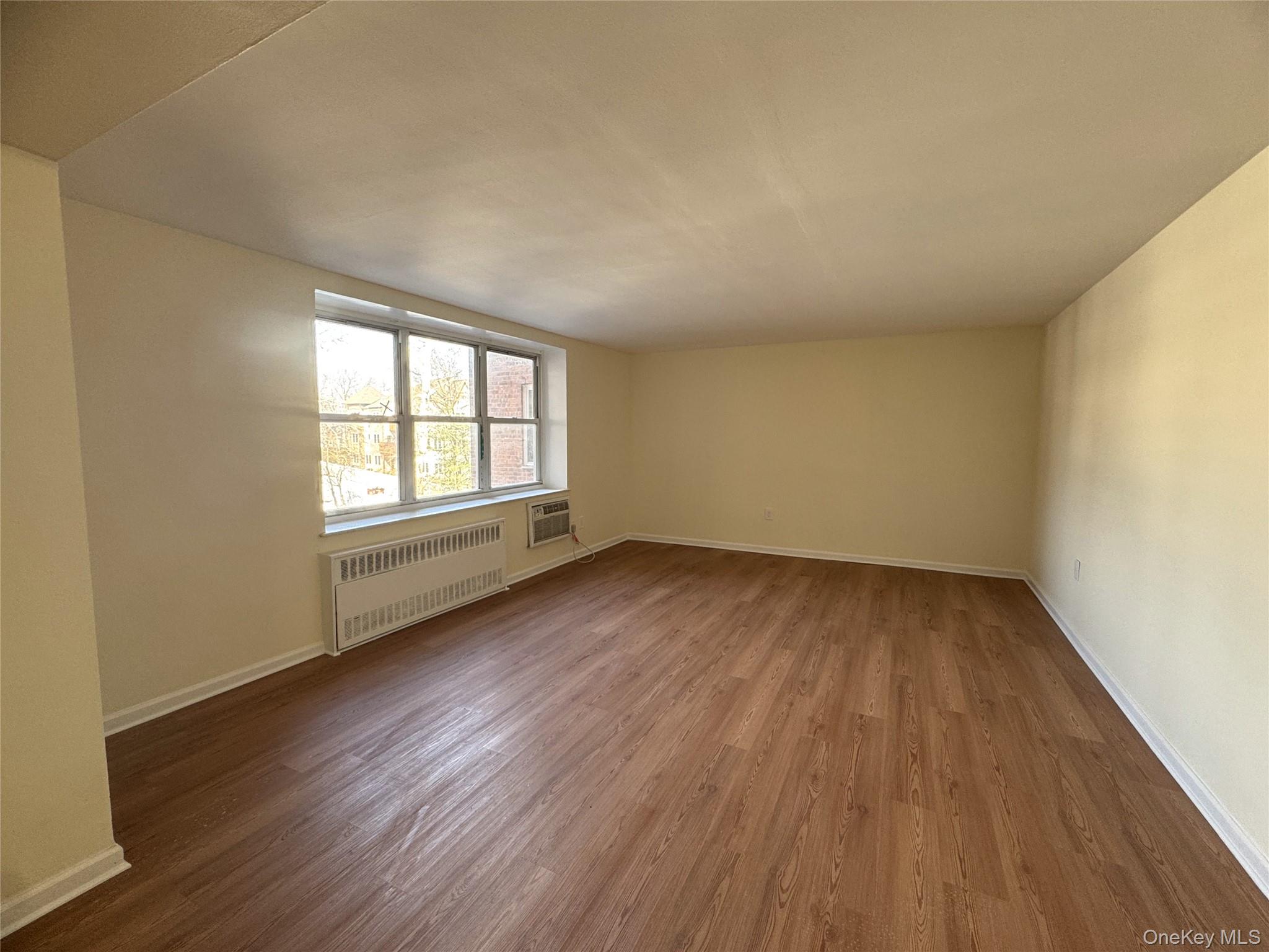30 South Cole Avenue, Unit 1L Spring Valley, NY 10977 - Photo 3 of 29 an empty room with wooden floor and windows