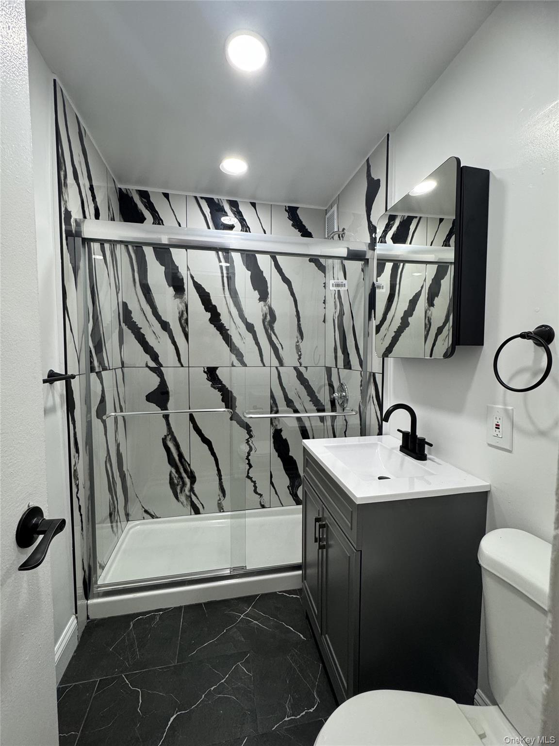 30 South Cole Avenue, Unit 1L Spring Valley, NY 10977 - Photo 10 of 29 a bathroom with a sink toilet and shower