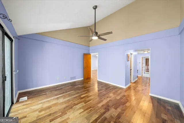 a view of hallway with wooden floor