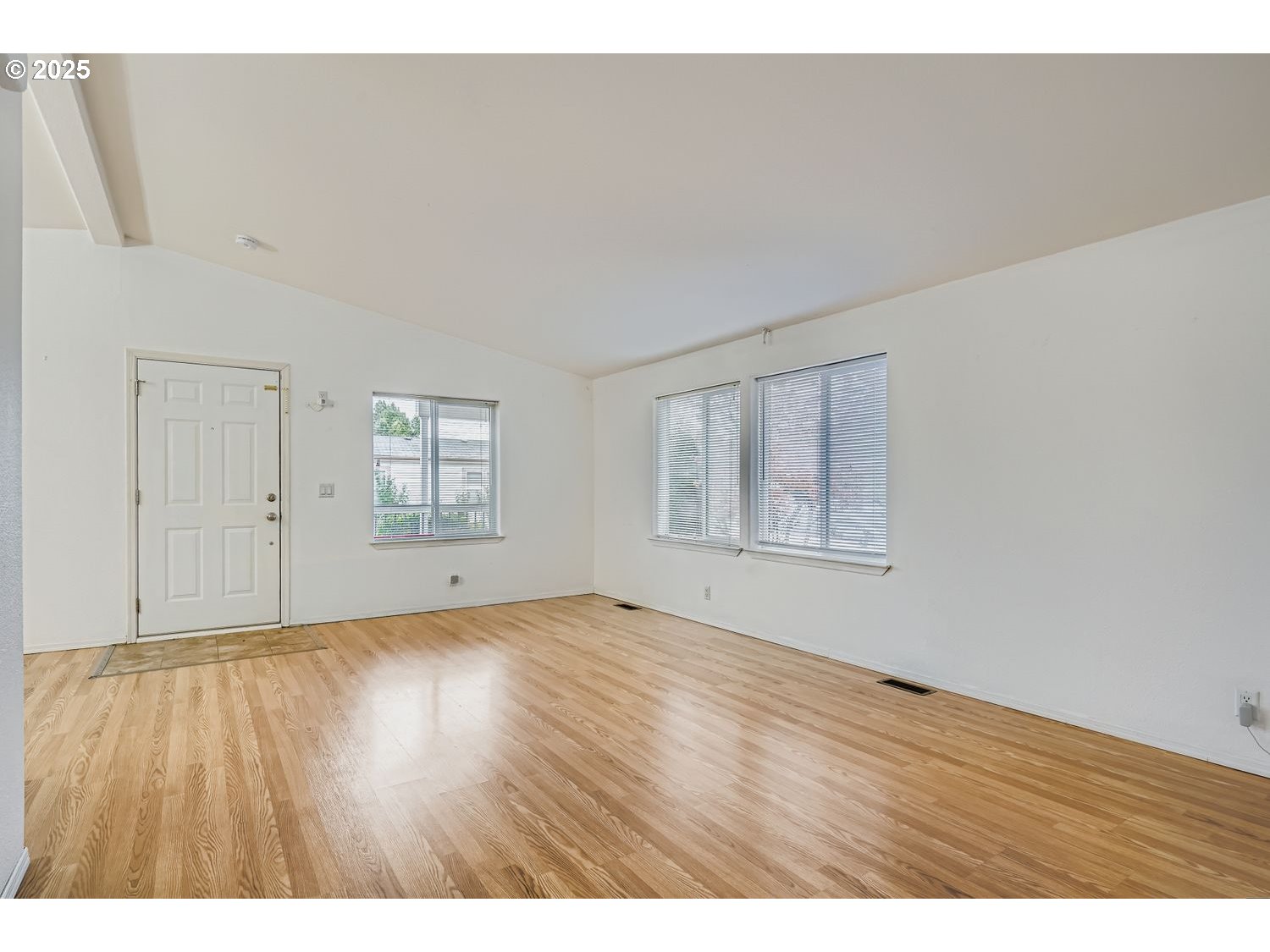 2111 Pippin Street Northeast Salem, OR 97305 - Photo 4 of 26 a view of an empty room with wooden floor and a window