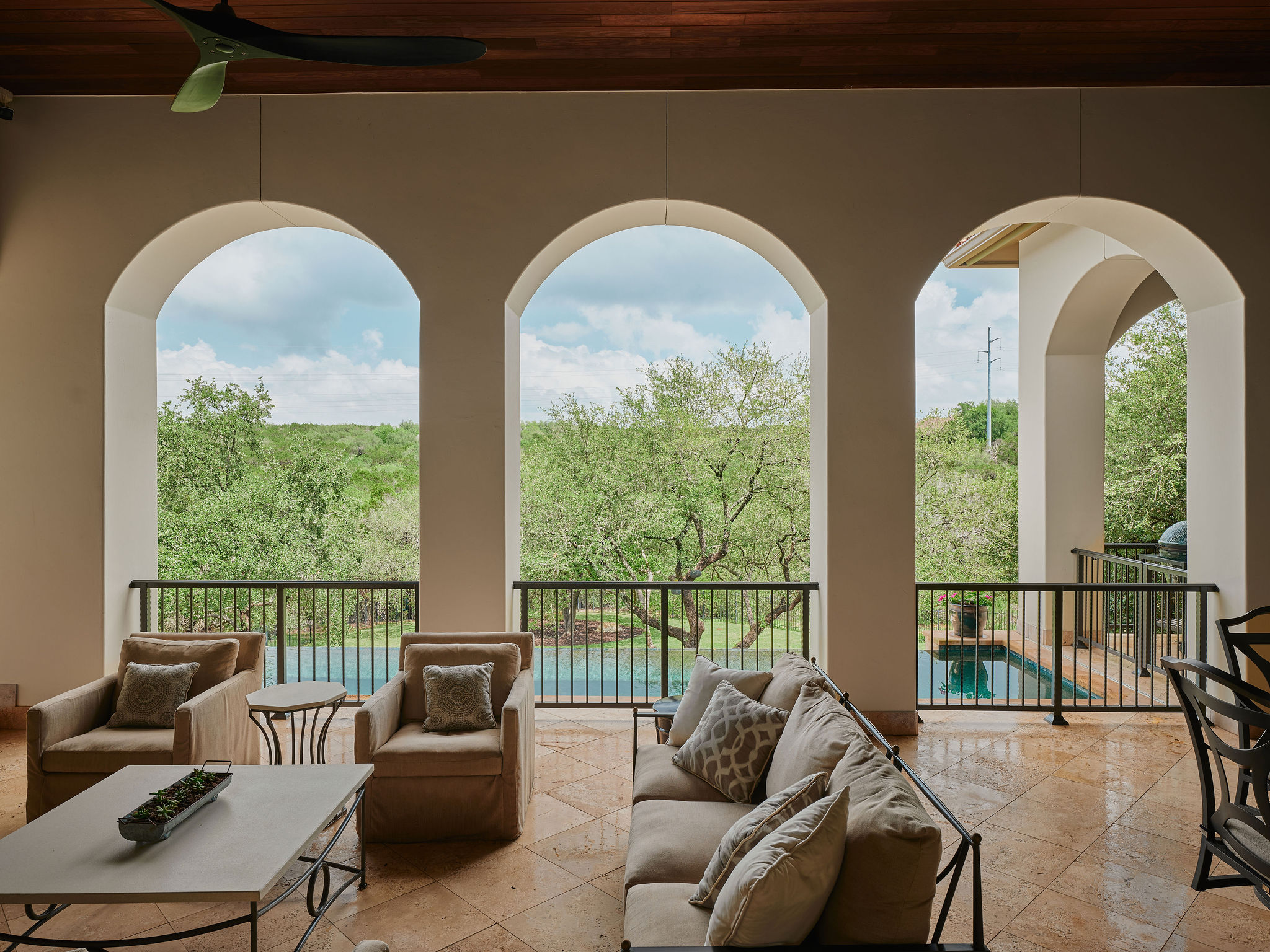 433 Brandon Way Austin, TX 78733 - Photo 23 of 40 Archways frame an inviting outdoor living space with pool views.