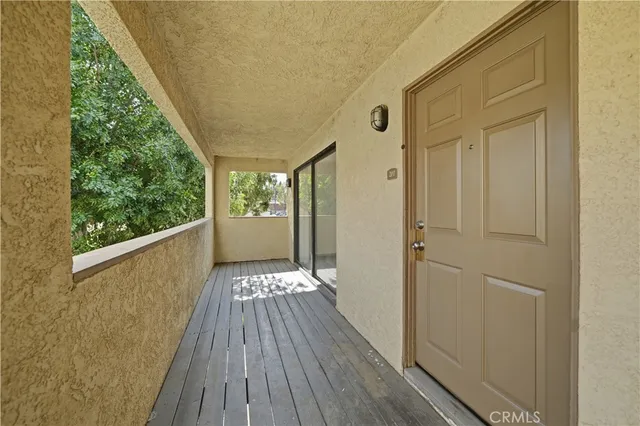 a view of balcony with wooden floor