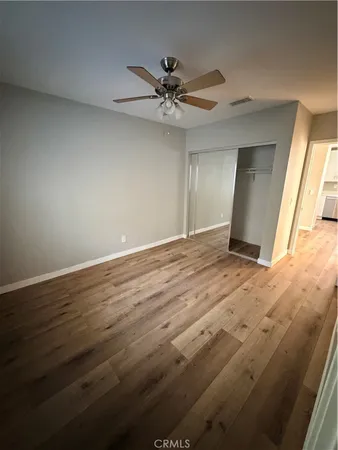 a view of a livingroom with a ceiling fan and window