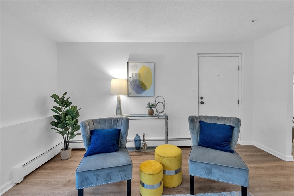 25 Pine Street, Unit B Canton, MA 02021 - Photo 7 of 23 a living room with furniture and a potted plant