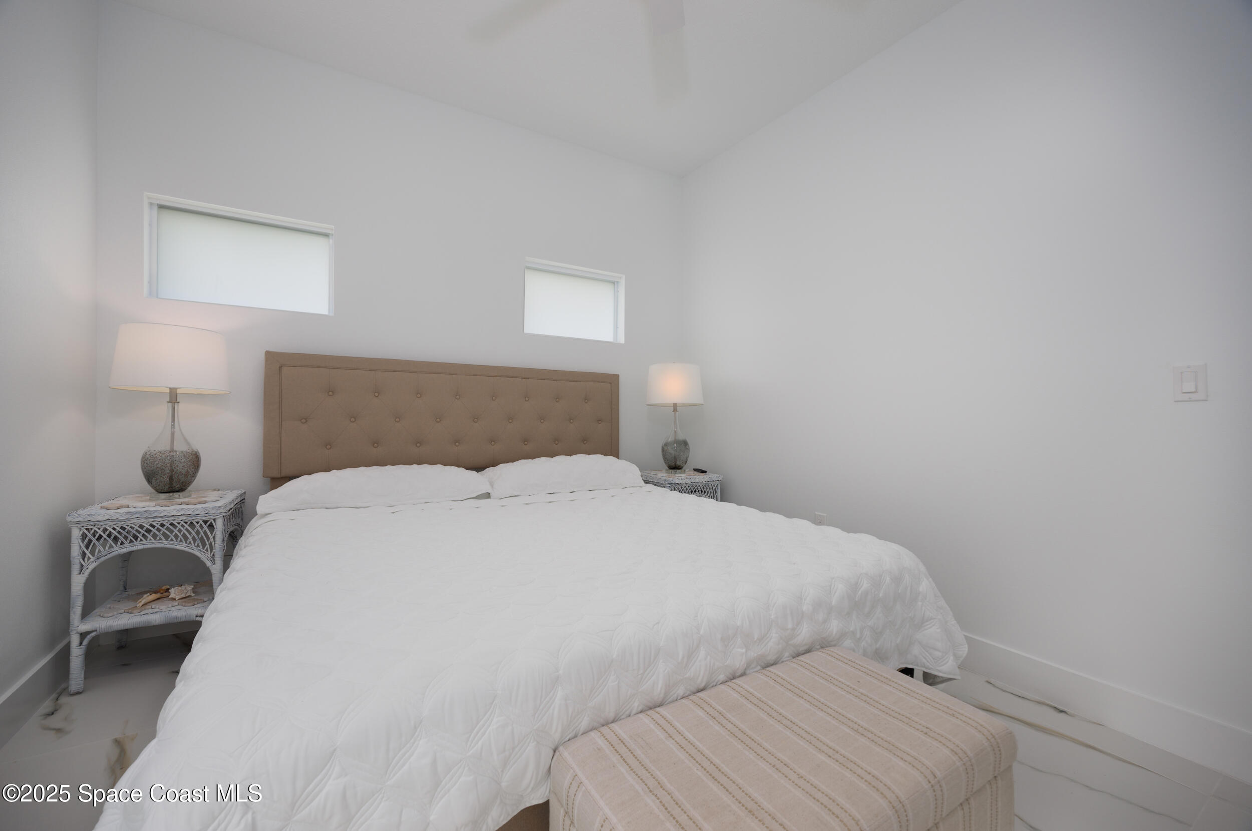 702 Shady Lane Melbourne, FL 32935 - Photo 12 of 14 a bedroom with a bed and a lamp