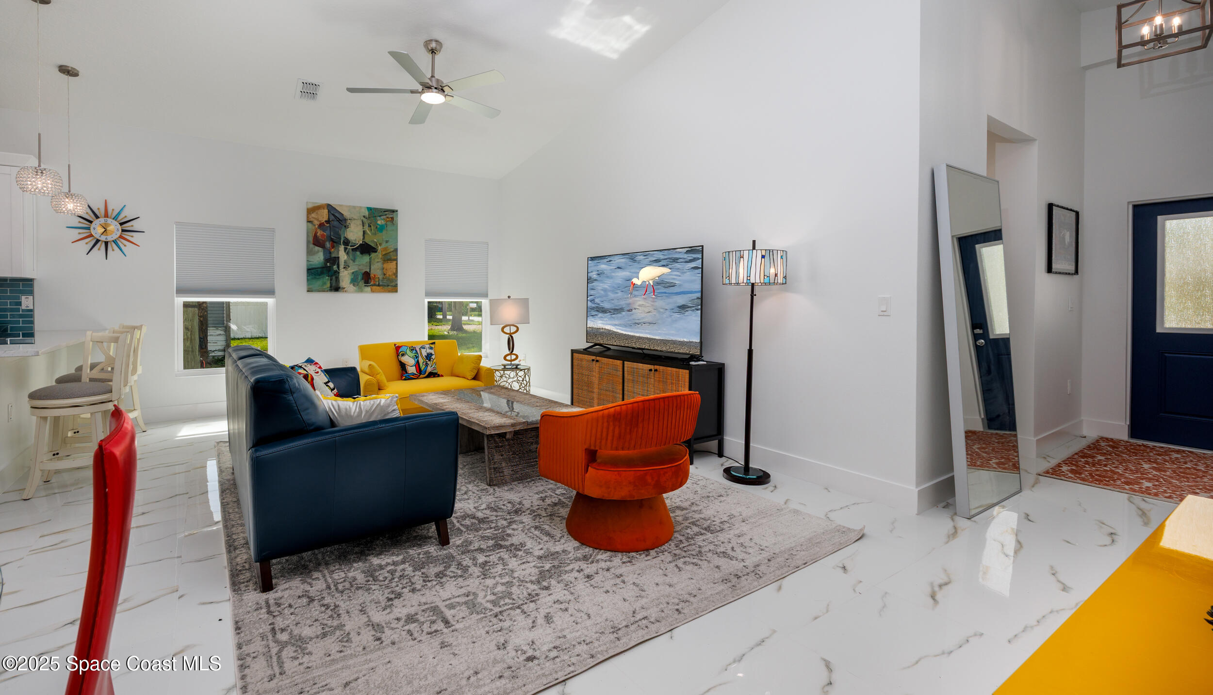 702 Shady Lane Melbourne, FL 32935 - Photo 5 of 14 a living room with furniture and a flat screen tv