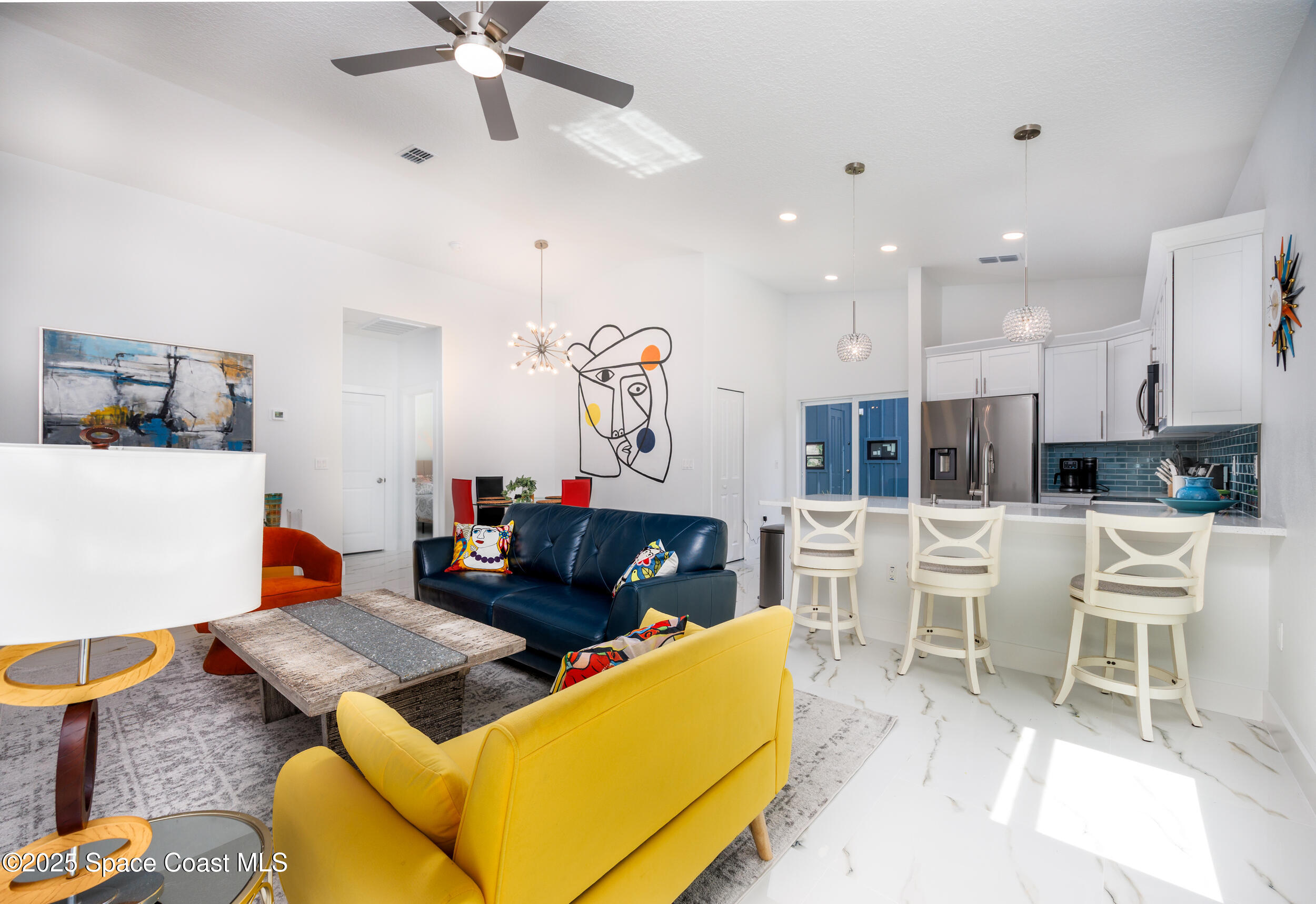 702 Shady Lane Melbourne, FL 32935 - Photo 6 of 14 a living room with furniture kitchen view and a large window
