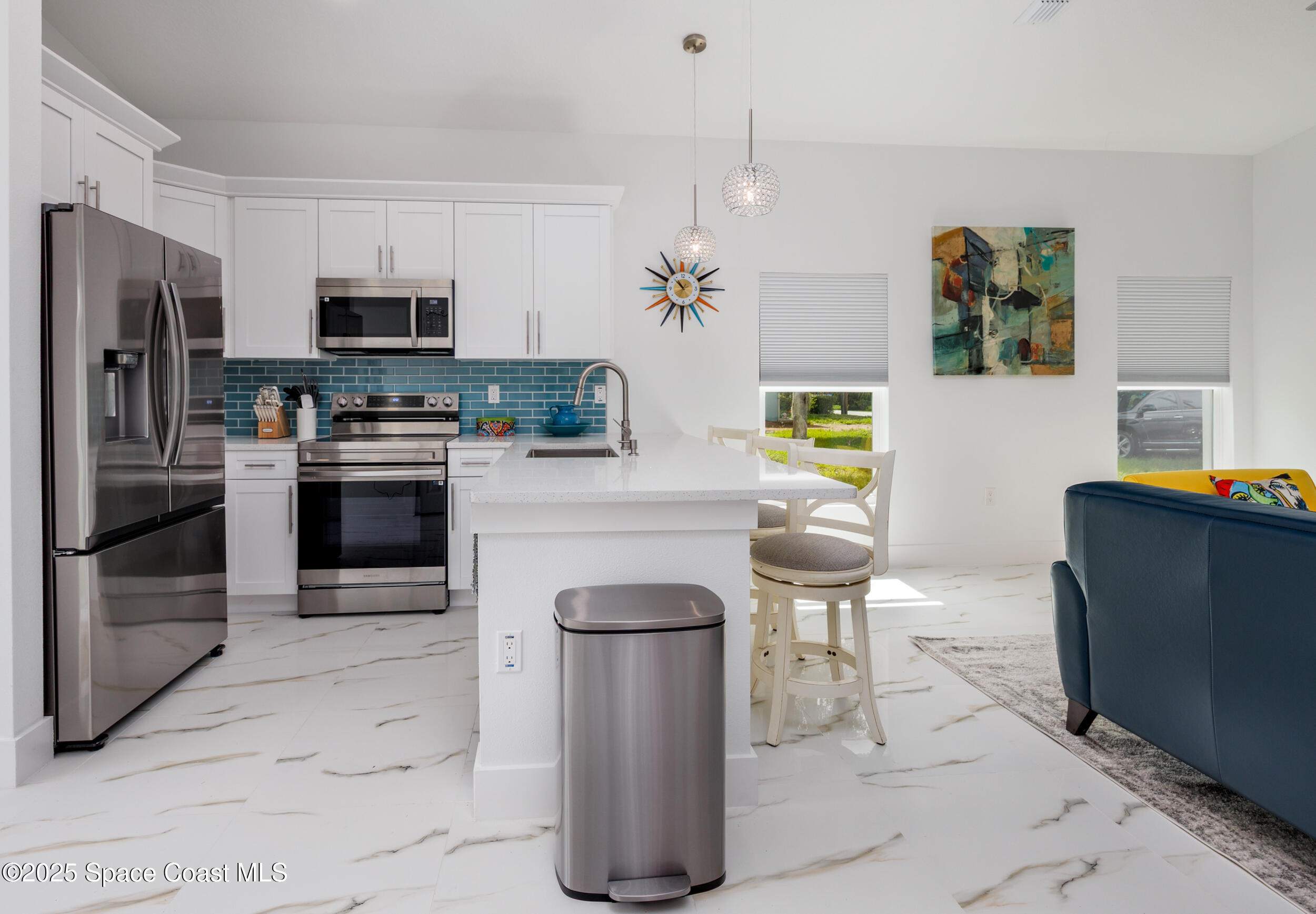 702 Shady Lane Melbourne, FL 32935 - Photo 7 of 14 a kitchen with stainless steel appliances granite countertop a refrigerator a stove a microwave a sink a counter top space and cabinets
