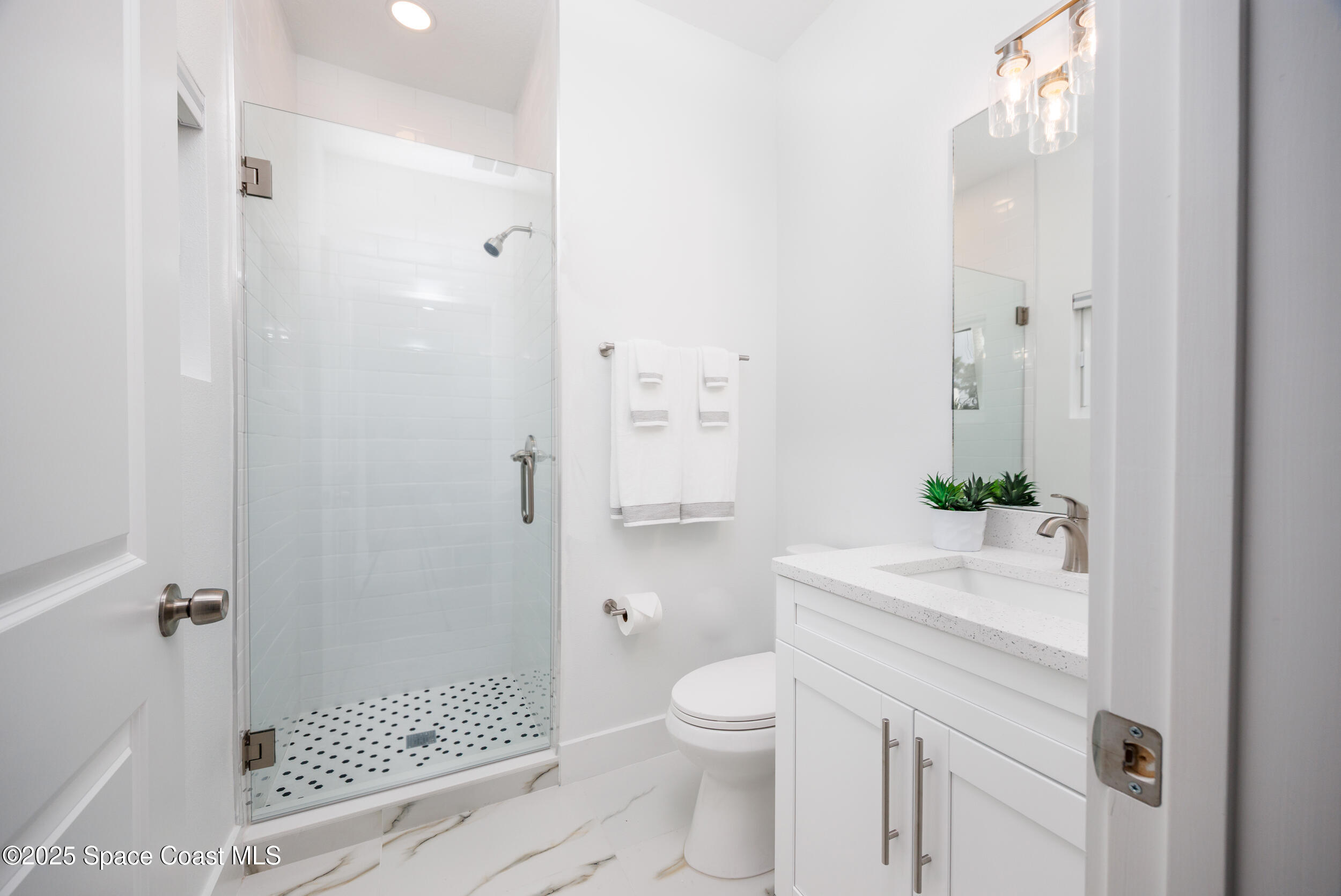 702 Shady Lane Melbourne, FL 32935 - Photo 10 of 14 a bathroom with a shower toilet and a sink