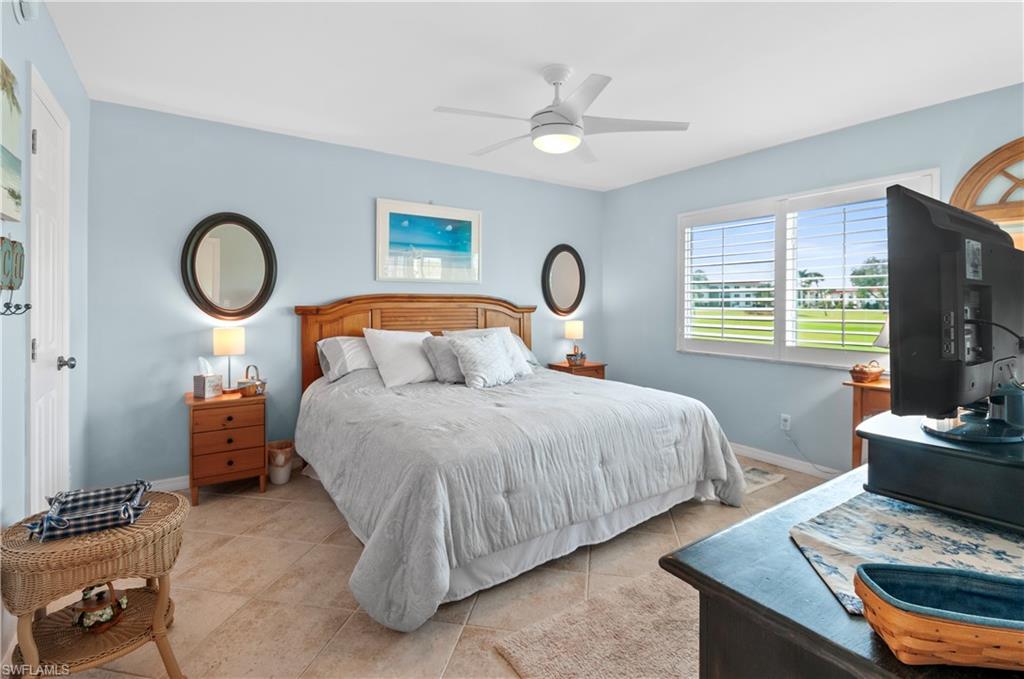 29 High Point Circle East, Unit 106 Naples, FL 34103 - Photo 15 of 42 a bedroom with bed and a window