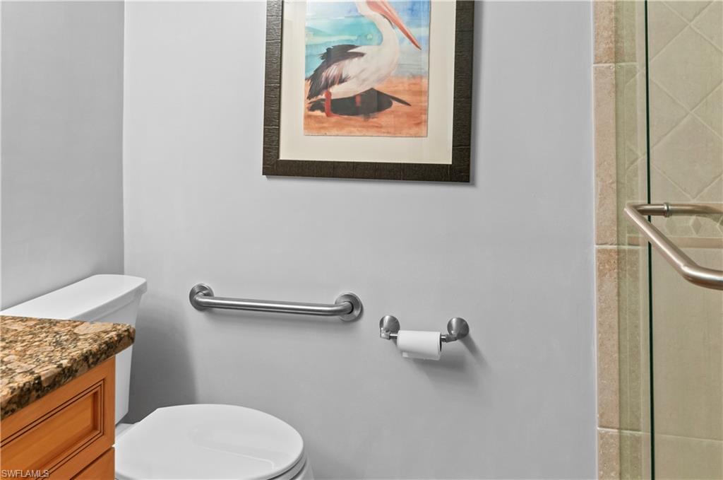29 High Point Circle East, Unit 106 Naples, FL 34103 - Photo 18 of 42 a bathroom with a granite countertop toilet and a sink