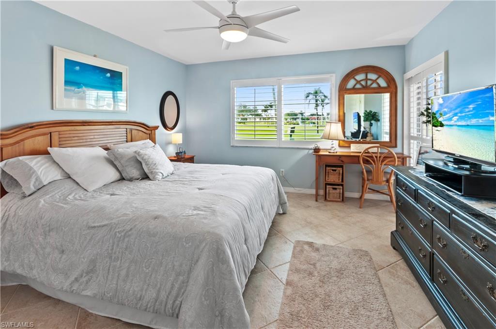 29 High Point Circle East, Unit 106 Naples, FL 34103 - Photo 20 of 42 a bedroom with a bed and a large window