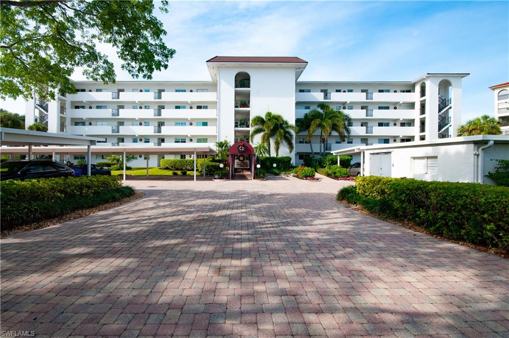 29 High Point Circle East, Unit 106 Naples, FL 34103 - Photo 2 of 42 a front view of a building with street view