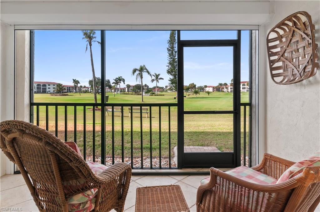 29 High Point Circle East, Unit 106 Naples, FL 34103 - Photo 22 of 42 a living room with large windows and furniture