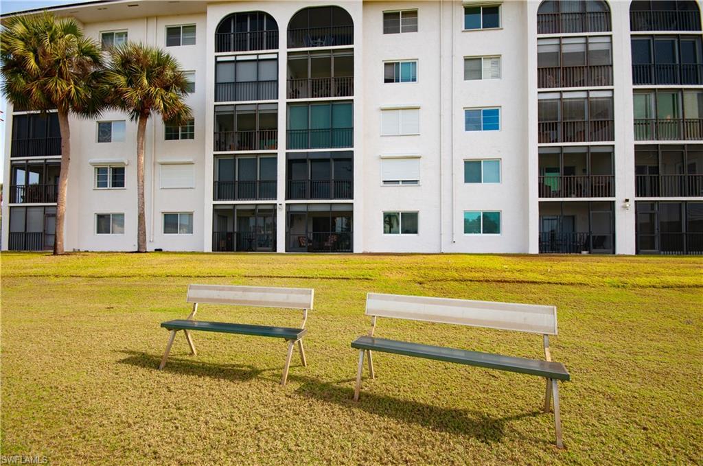 29 High Point Circle East, Unit 106 Naples, FL 34103 - Photo 23 of 42 a view of swimming pool with outdoor seating