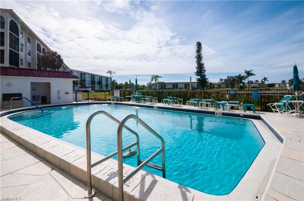 29 High Point Circle East, Unit 106 Naples, FL 34103 - Photo 24 of 42 a view of swimming pool from a balcony