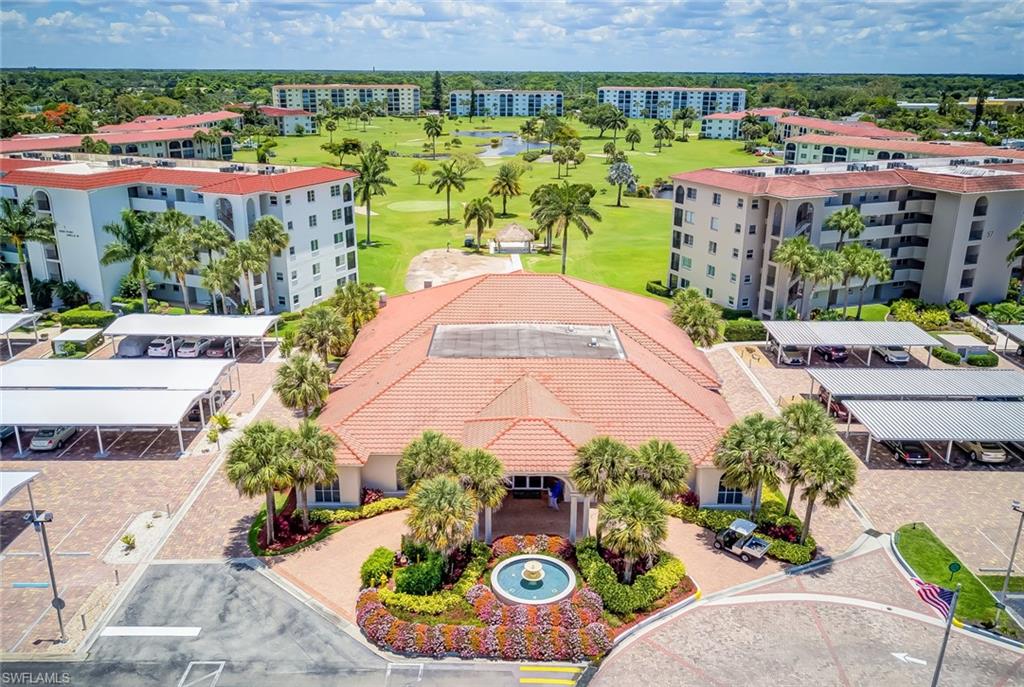 29 High Point Circle East, Unit 106 Naples, FL 34103 - Photo 29 of 42 a view of a swimming pool with a patio