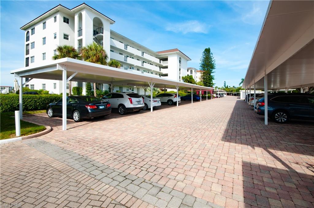 29 High Point Circle East, Unit 106 Naples, FL 34103 - Photo 3 of 42 a view of a building with a porch
