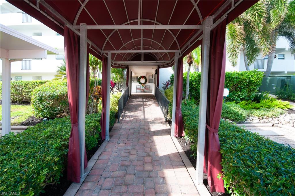 29 High Point Circle East, Unit 106 Naples, FL 34103 - Photo 4 of 42 a view of a pathway door front of house