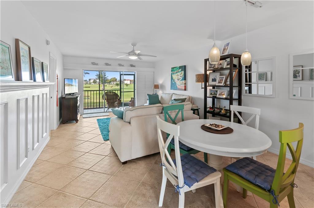 29 High Point Circle East, Unit 106 Naples, FL 34103 - Photo 6 of 42 a living room with furniture a chandelier and a dining table
