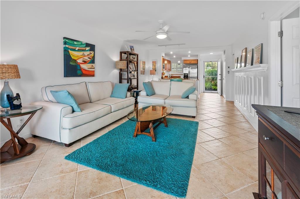 29 High Point Circle East, Unit 106 Naples, FL 34103 - Photo 7 of 42 a living room with furniture and a rug
