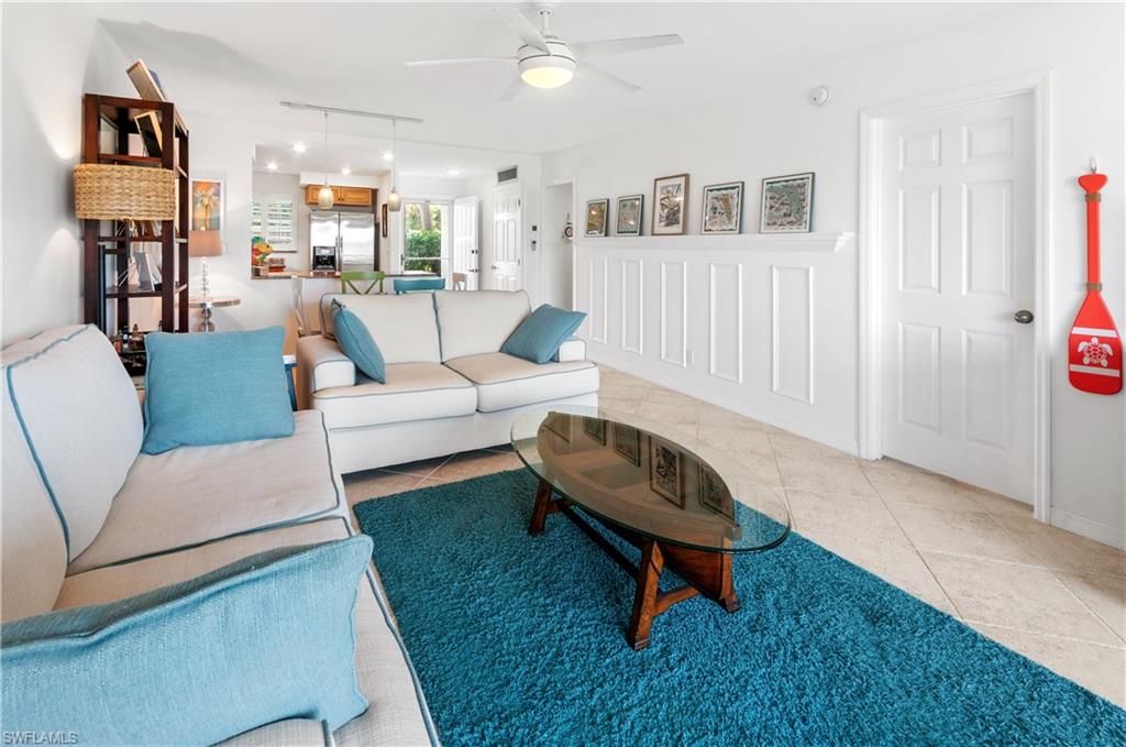 29 High Point Circle East, Unit 106 Naples, FL 34103 - Photo 8 of 42 a living room with furniture and a rug