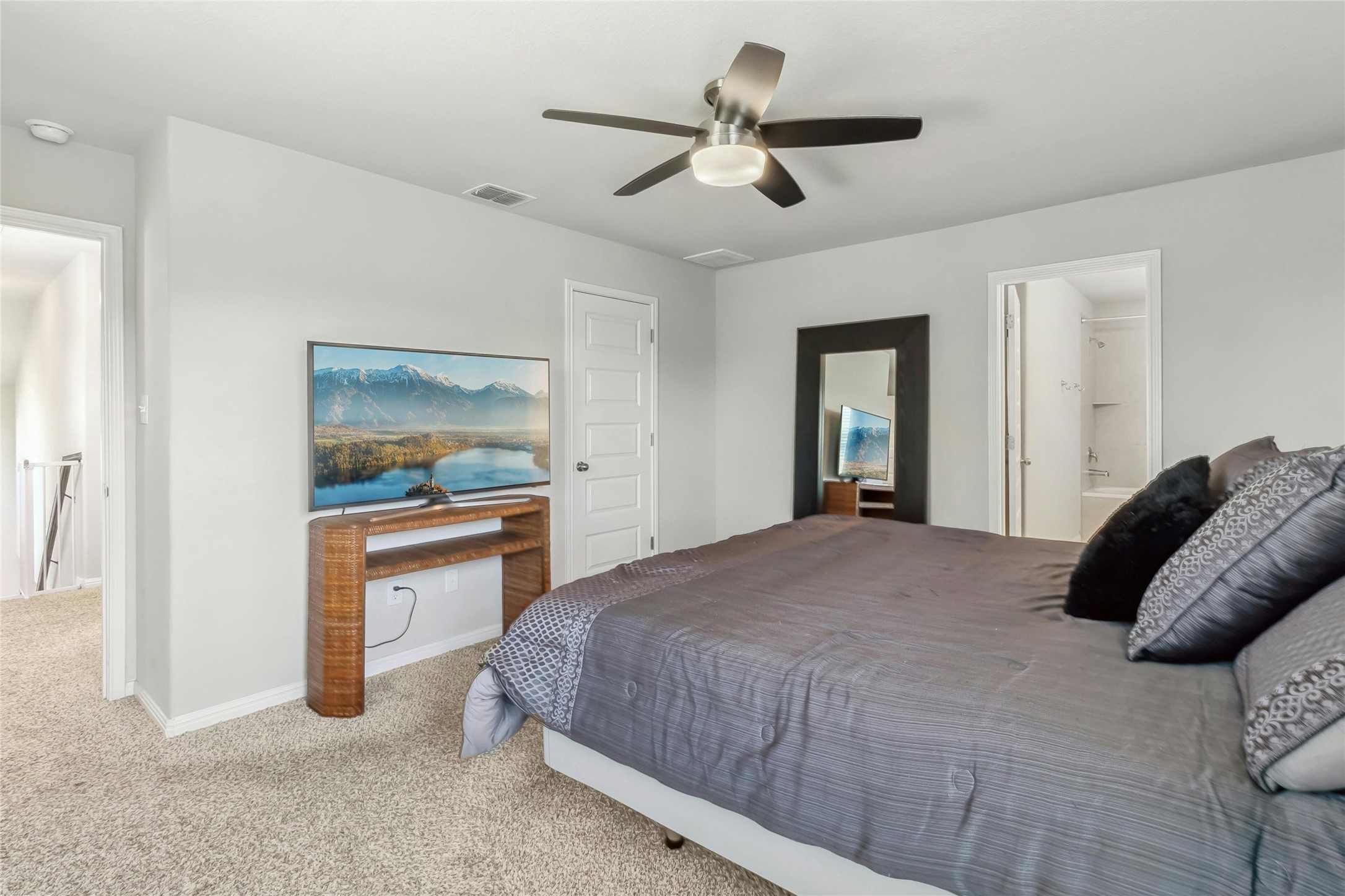 112 Silver Spgs Bend Kyle, TX 78640 - Photo 16 of 33 Spacious primary bedroom suite found at the top of the stairway.