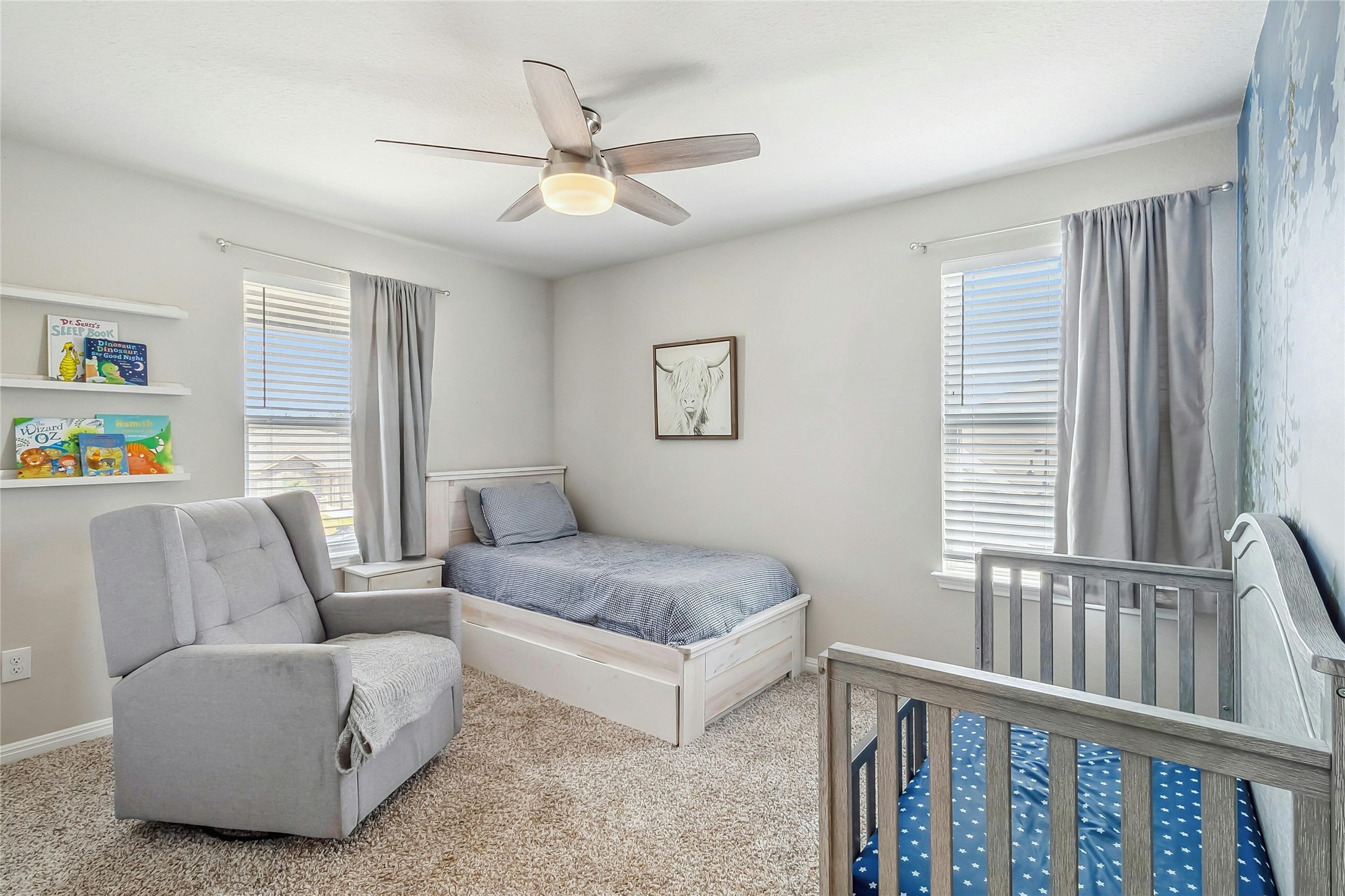 112 Silver Spgs Bend Kyle, TX 78640 - Photo 23 of 33 The second of 4 upstairs bedrooms. Light & bright with 2 windows allowing natural light, clean carpet & energy efficient ceiling fans.