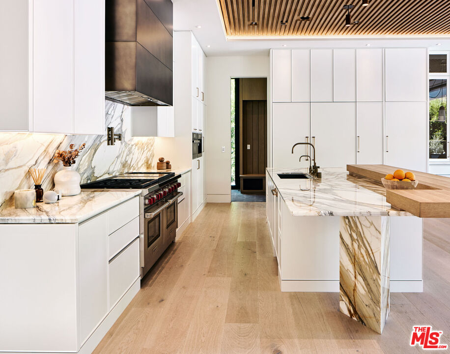 740 Warner Avenue Los Angeles, CA 90024 - Photo 13 of 53 a kitchen with a sink and a stove top oven