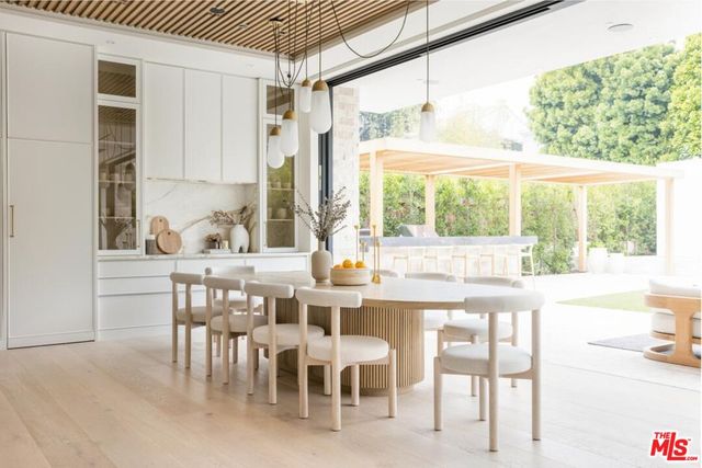 a dining room with furniture a chandelier and wooden floor