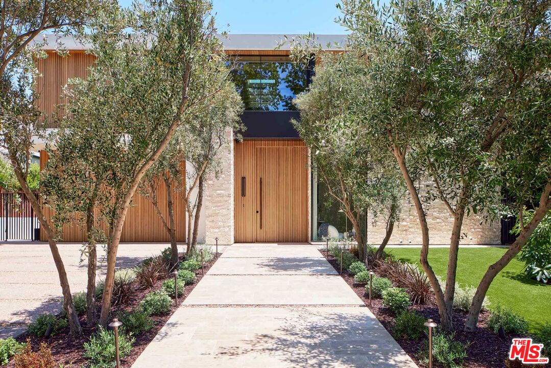740 Warner Avenue Los Angeles, CA 90024 - Photo 2 of 53 a front view of a house with a yard and fountain