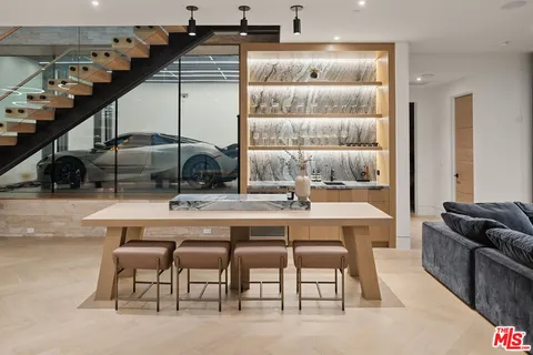 a dining table with chairs and window