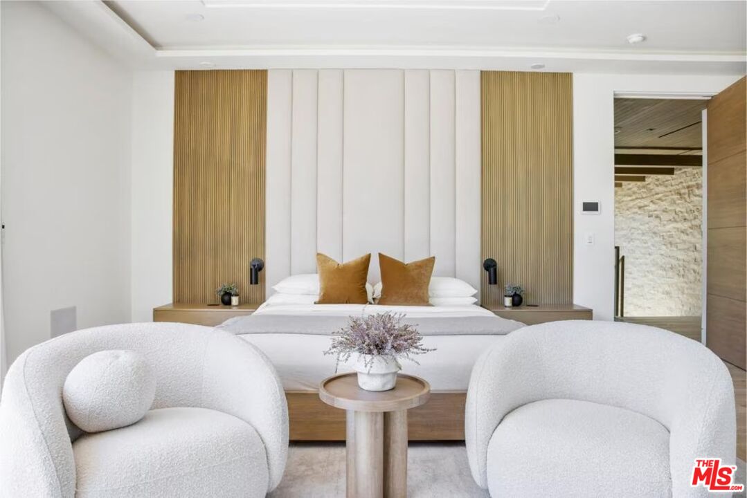 740 Warner Avenue Los Angeles, CA 90024 - Photo 26 of 53 a bedroom with a bed and a chandelier