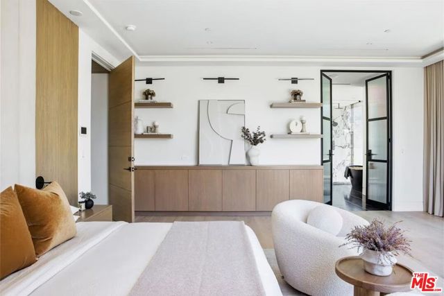 a room with a glass door shower and a table