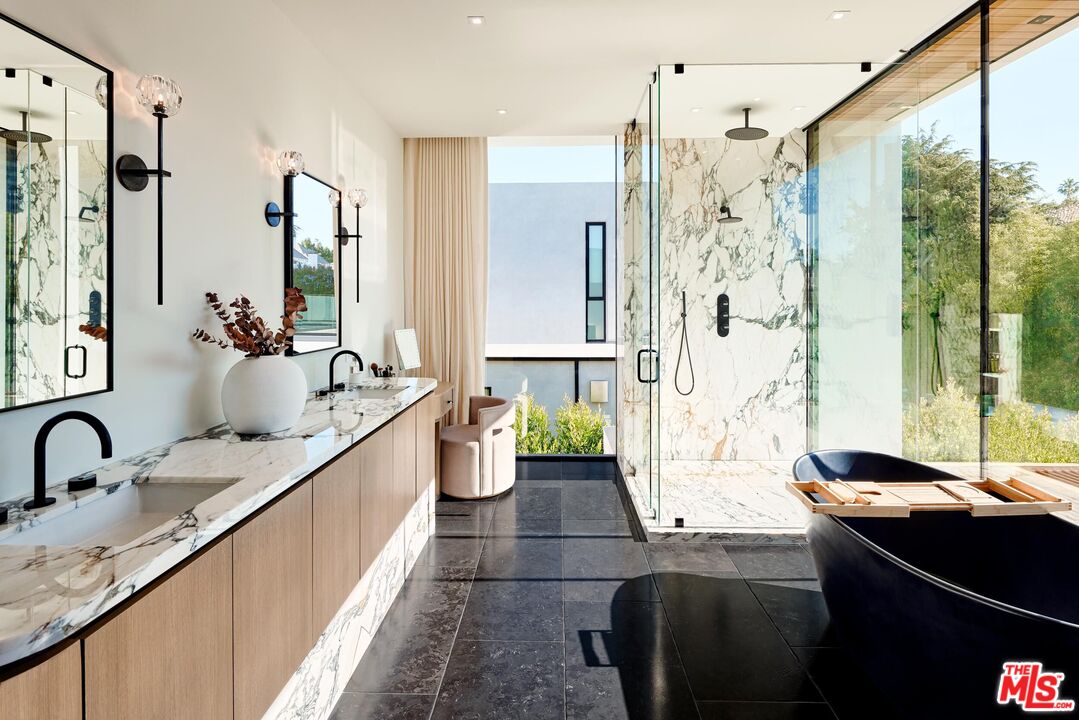 740 Warner Avenue Los Angeles, CA 90024 - Photo 28 of 53 a large bathroom with a granite countertop tub a sink and a shower