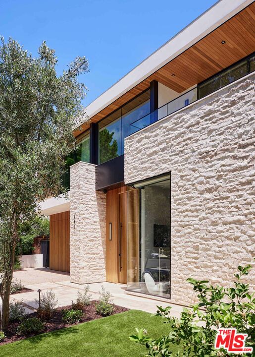 740 Warner Avenue Los Angeles, CA 90024 - Photo 3 of 53 a front view of a house with a yard