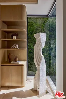 a view of a patio with a table and chairs under an umbrella with a small yard