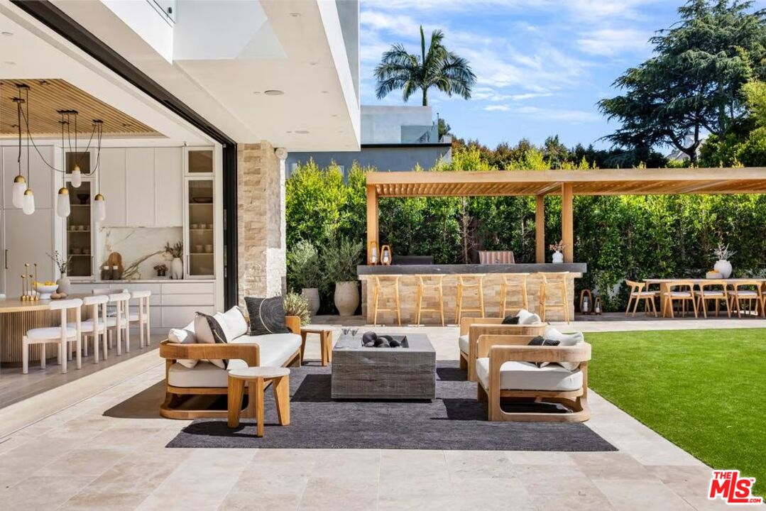 740 Warner Avenue Los Angeles, CA 90024 - Photo 37 of 53 a living room with patio furniture and a garden