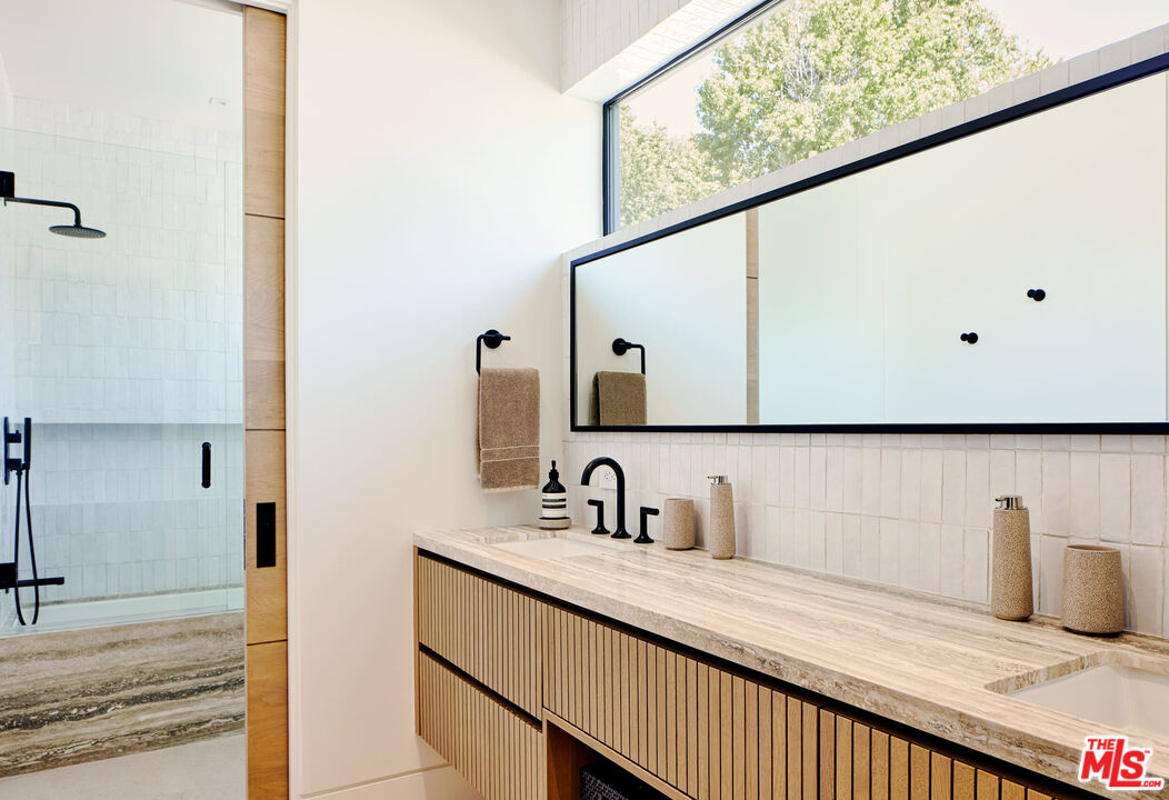 740 Warner Avenue Los Angeles, CA 90024 - Photo 52 of 53 a bathroom with a sink and a mirror