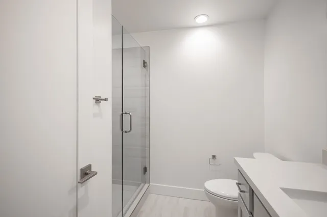 a bathroom with a toilet and a shower