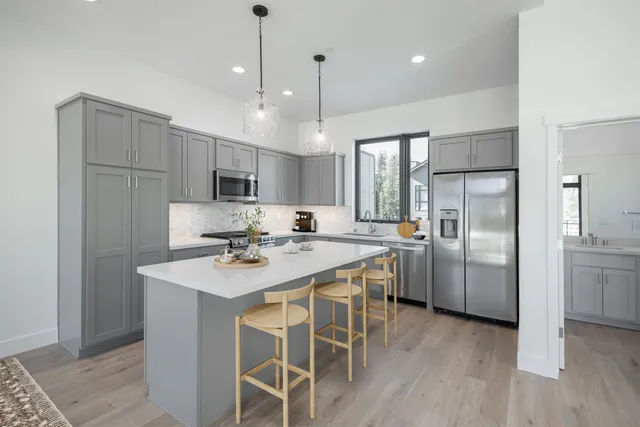 a kitchen with refrigerator cabinets and wooden floor
