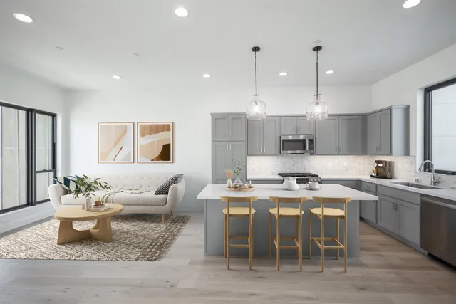 a large kitchen with a table and chairs