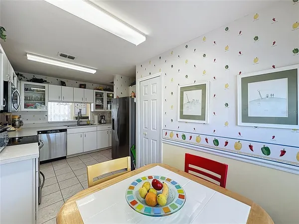 a kitchen with stainless steel appliances a stove a refrigerator and cabinets