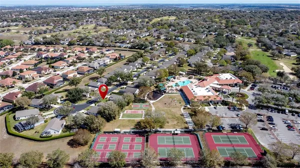 a large hall with stainless steel appliances granite countertop lots of wooden furniture