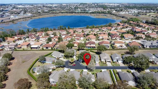 a kitchen with a table chairs refrigerator and cabinets