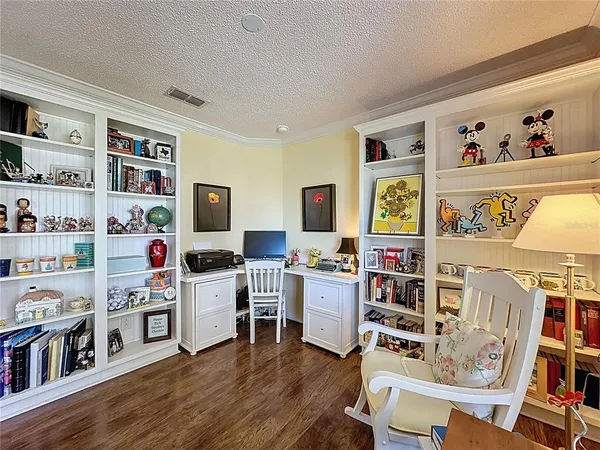 a living room with lots of furniture and book shelf