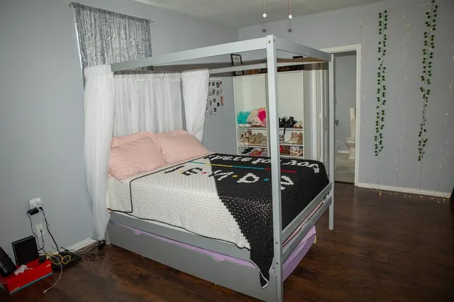 a bed room with a bed and a window