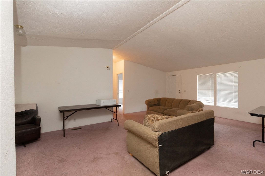 7374 Windmill Road Kingman, AZ 86401 - Photo 13 of 49 a living room with furniture and a window
