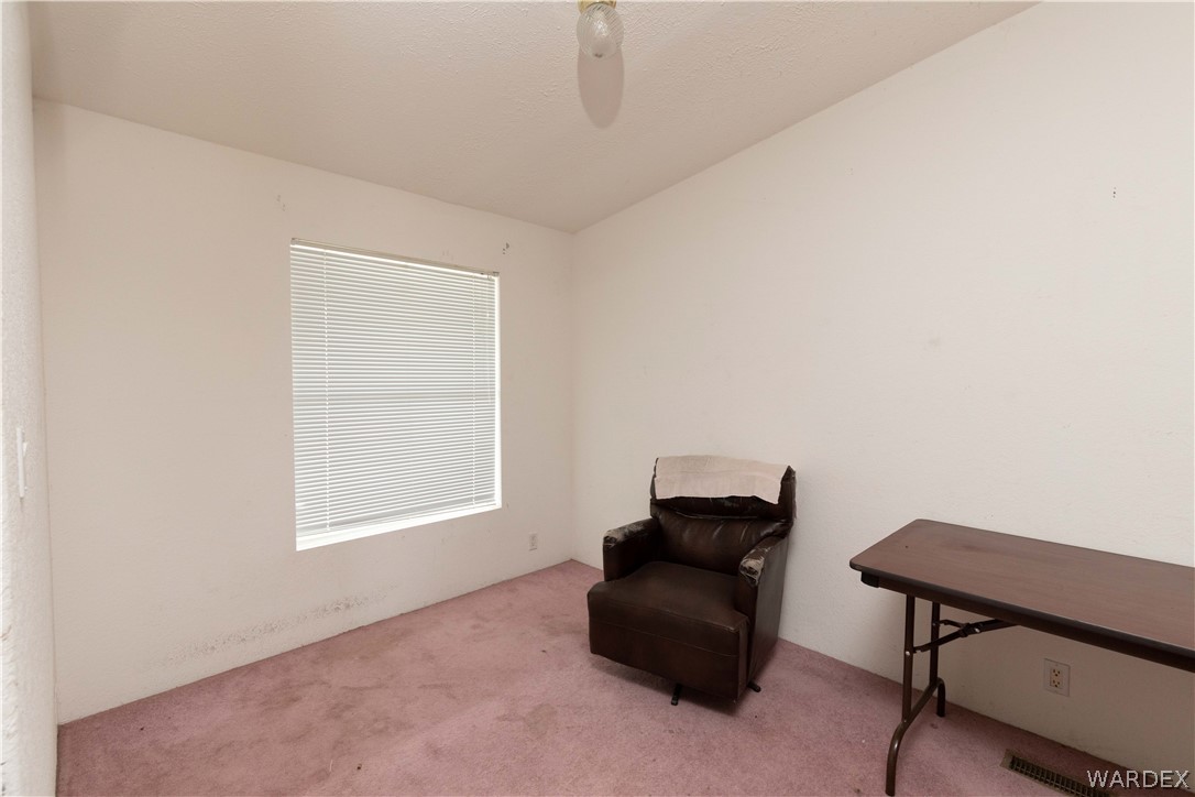 7374 Windmill Road Kingman, AZ 86401 - Photo 14 of 49 a room with furniture and a window